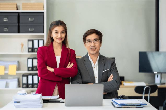 man and woman posing in the office