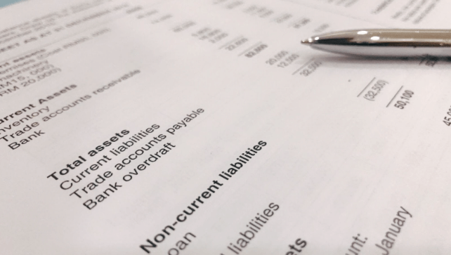 financial report with a pen on top